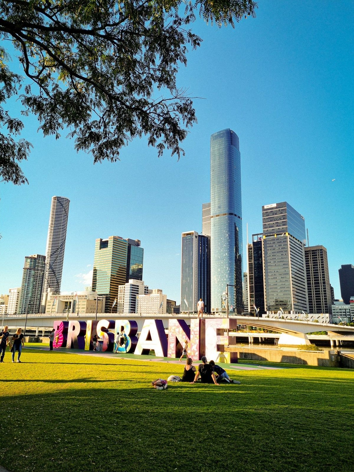 The Brisbane sign at South Bank with the city skyline behind it