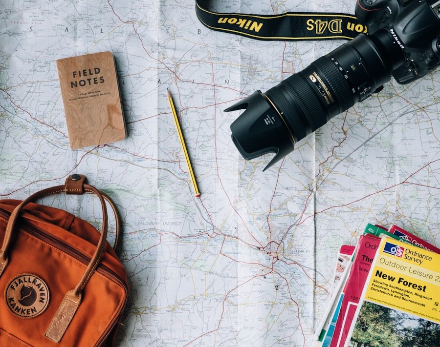 Travel map, notebook and camera laid out for planning a journey